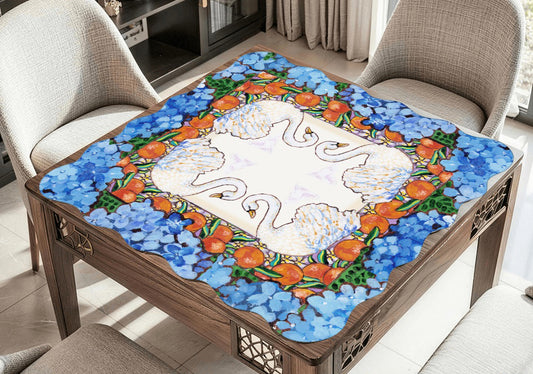 A scalloped mahjong mat featuring an original painting of swans, oranges, orange blossoms and hydrangeas.