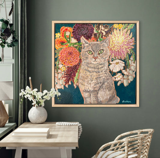 This painting is a loving portrait of Moses my gray cat shown sitting calmly in front of a rich bouquet of flowers including vibrant dahlias.