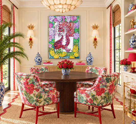 A painting of a red dragon mahjong tile surrounded by flowers and pineapples by Trail East Studio in Ada Michigan