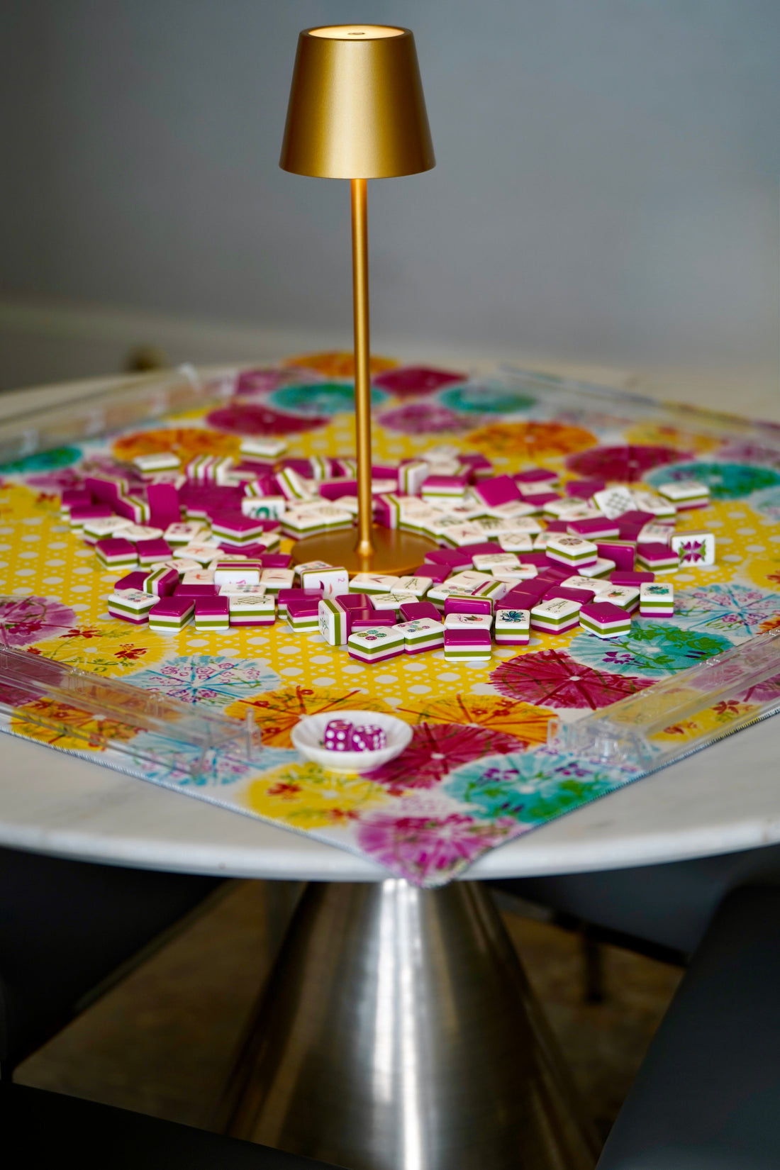 A mahjong table with a original painting mahjong mat, tiles, racks and a mahjong table lamp