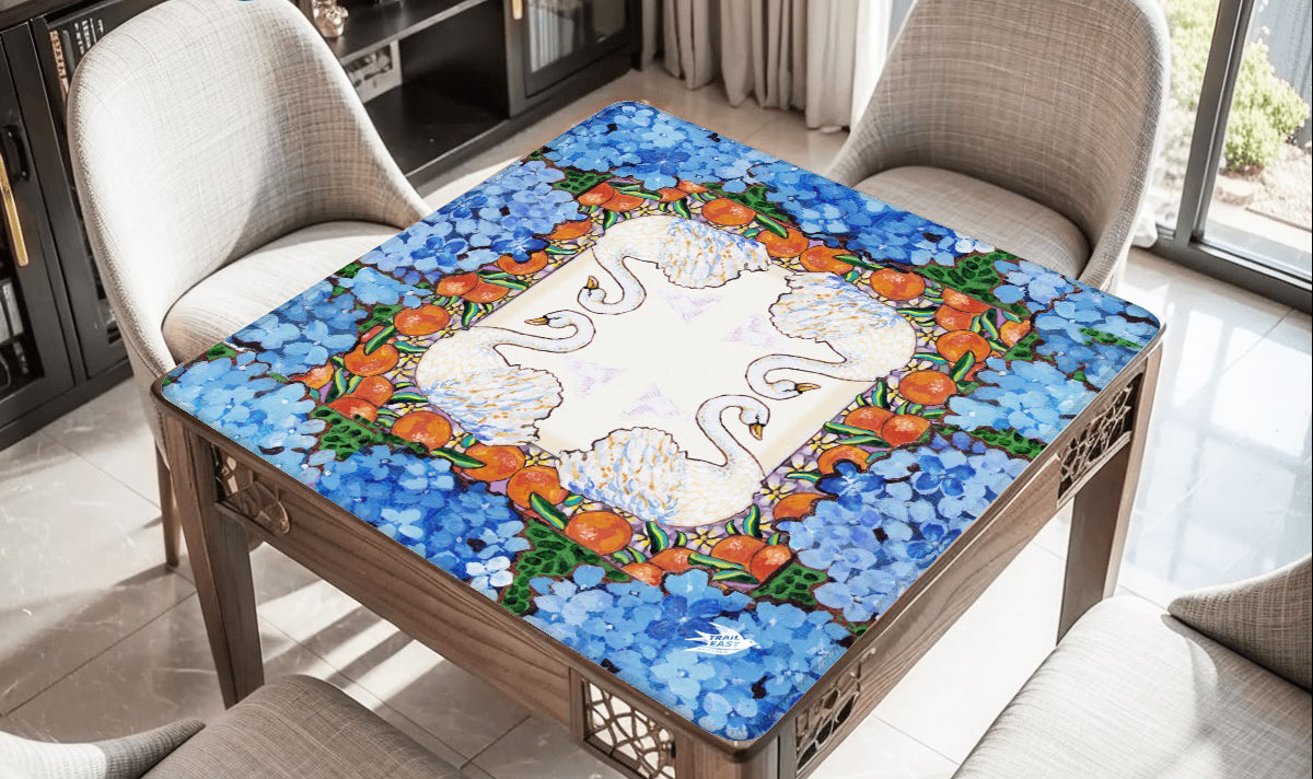 A colorful mahjong mat featuring an original painting of swans, oranges, orange blossoms and hydrangeas.