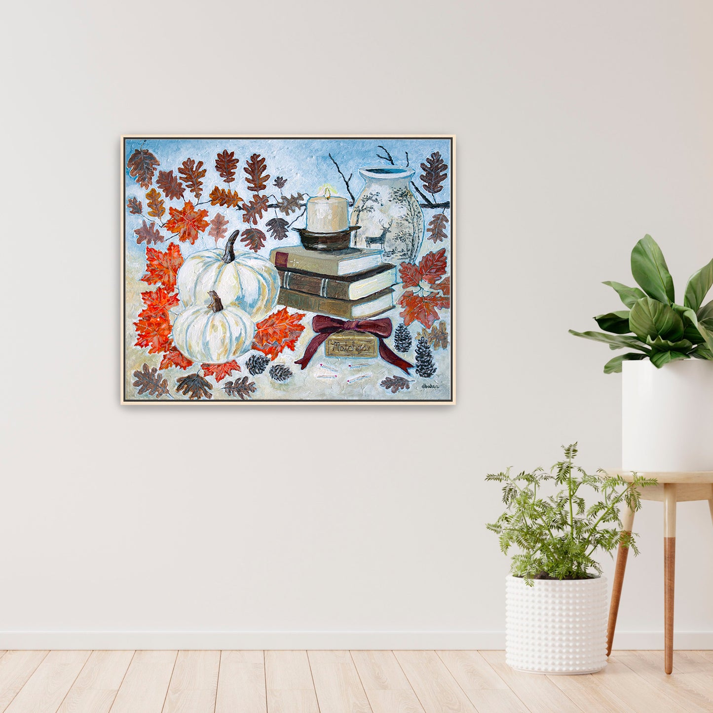 A painting of a cozy autumn still life featuring white pumpkins, vintage books, a red velvet bow and warm fall leaves. A perfect rustic accent for your home decor.