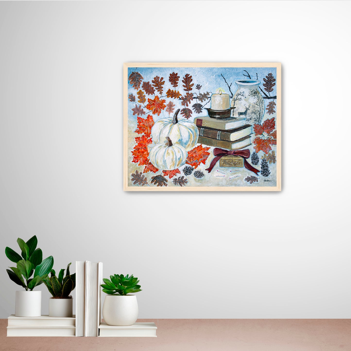 A painting of a cozy autumn still life featuring white pumpkins, vintage books, a red velvet bow and warm fall leaves. A perfect rustic accent for your home decor.