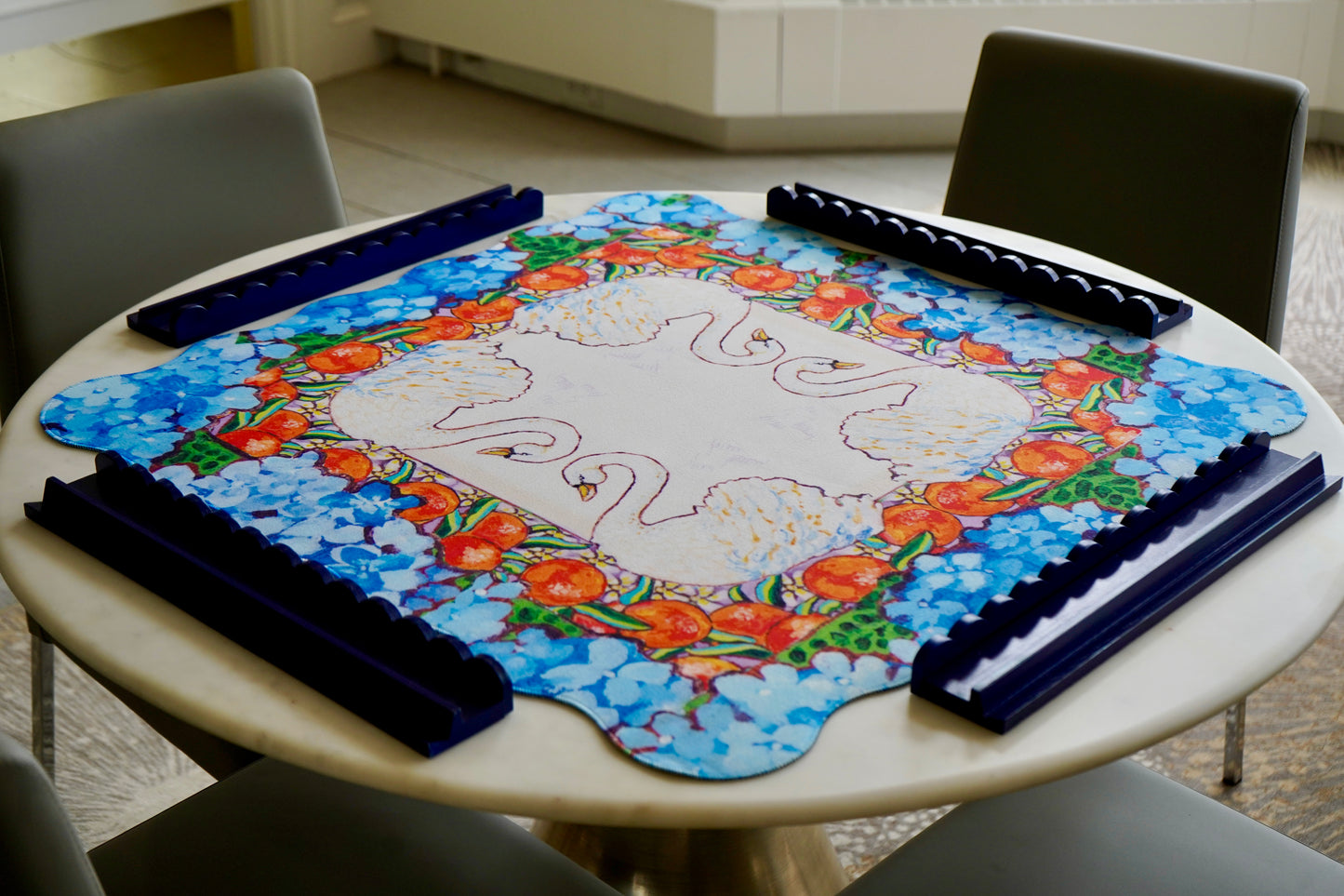 A colorful mahjong mat featuring an original painting of swans, oranges, orange blossoms and hydrangeas.