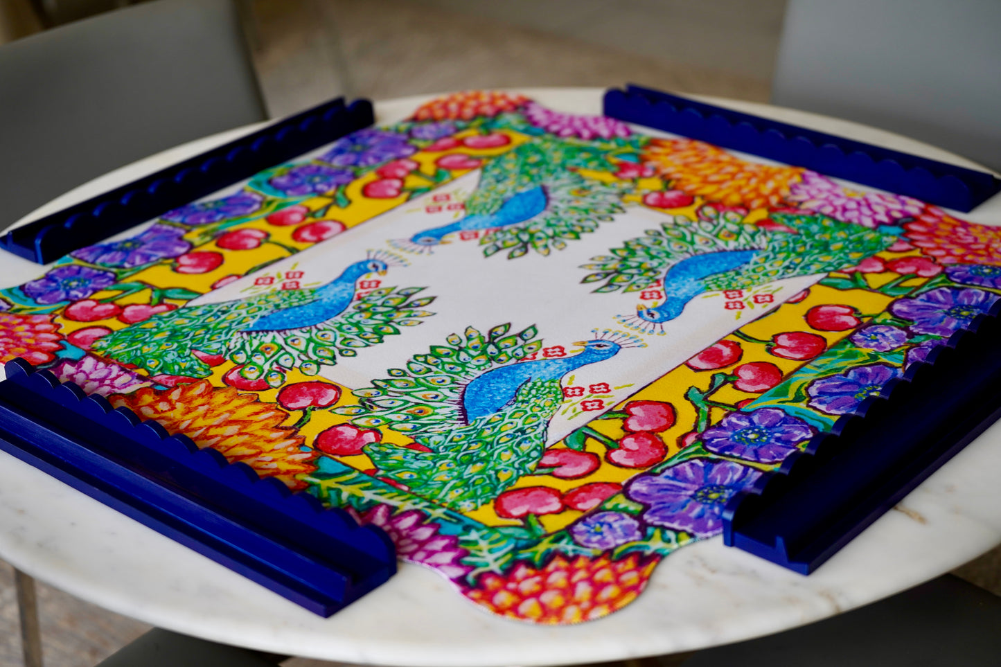 A colorful mahjong mat featuring an original painting of peacocks, cherries, dahlias and anemones flowers.
