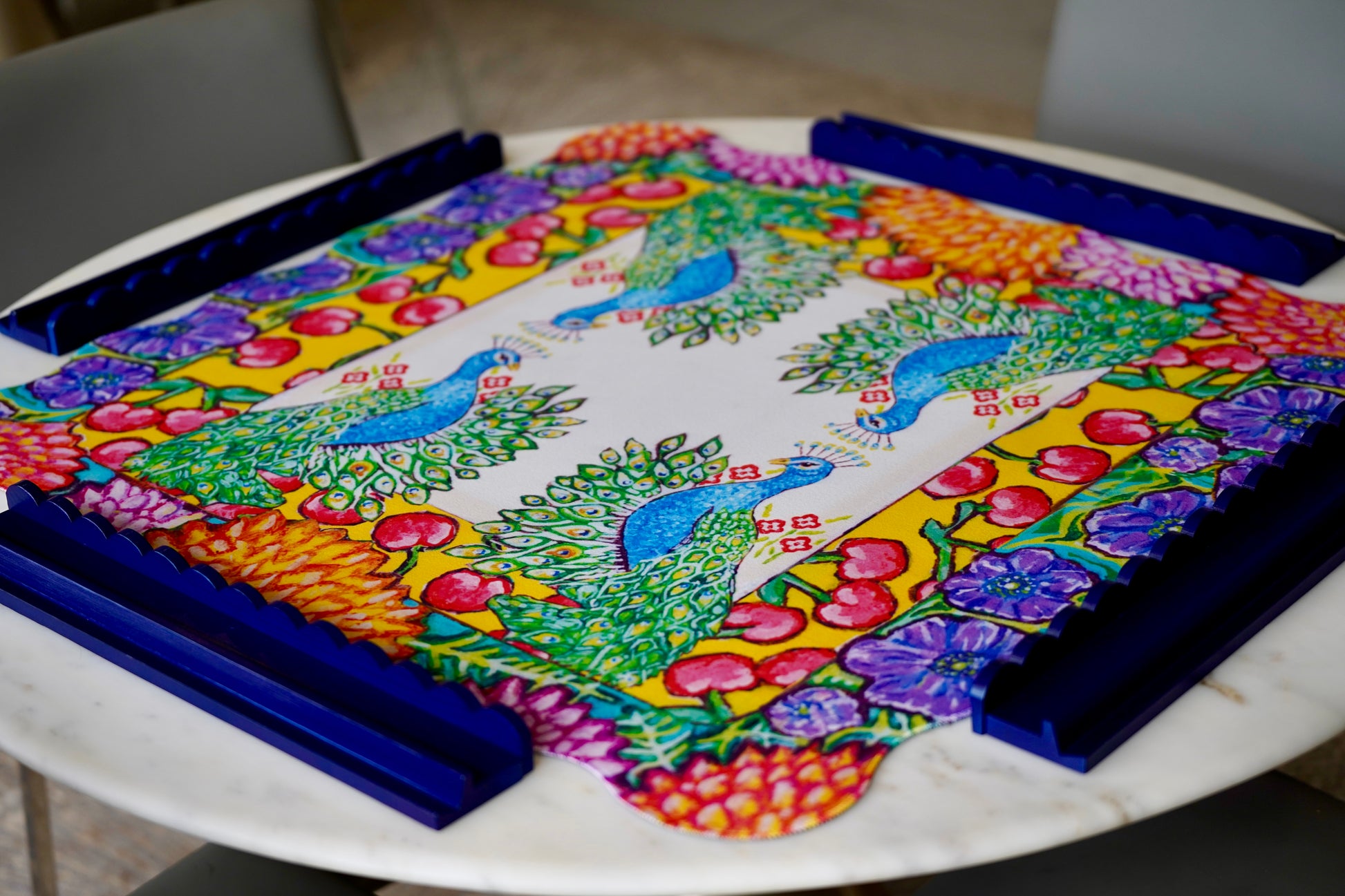 A colorful mahjong mat featuring an original painting of peacocks, cherries, dahlias and anemones flowers.