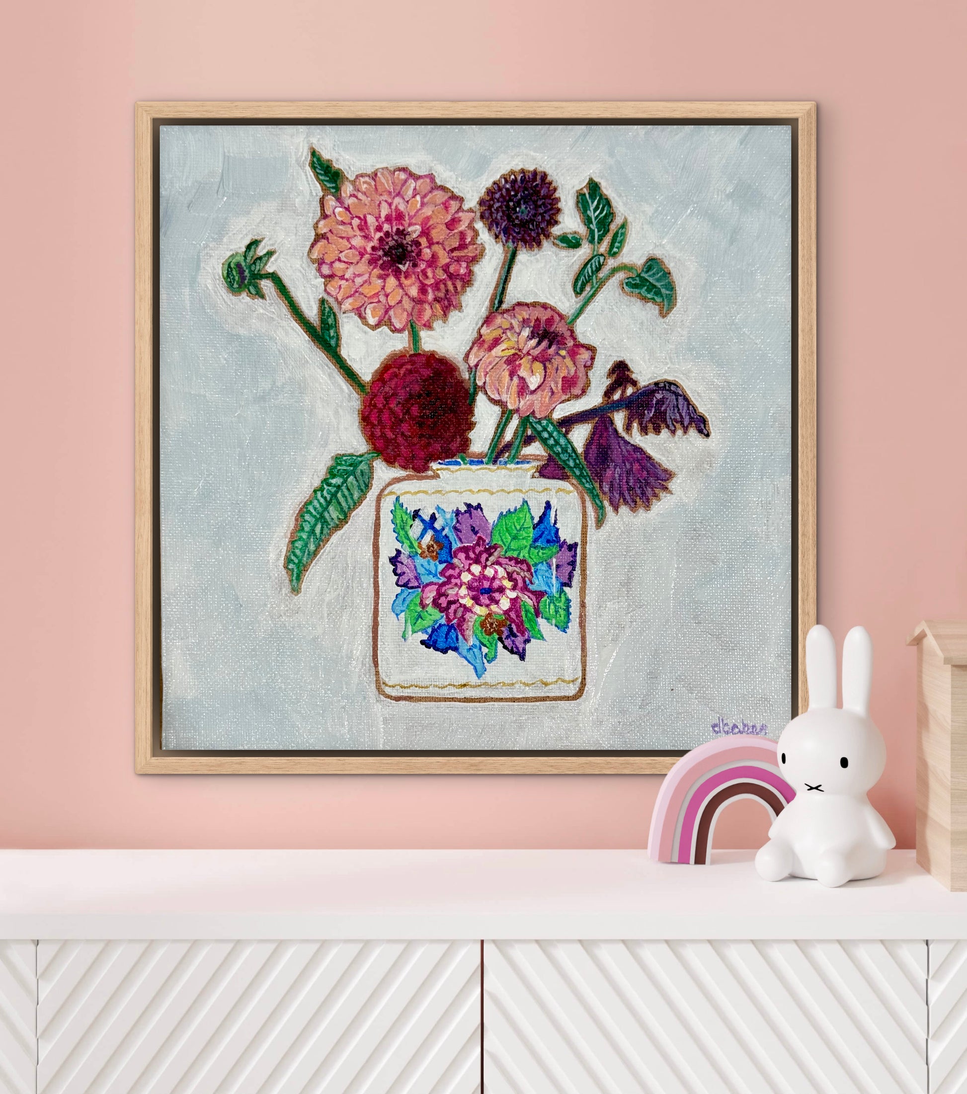 Vibrant dahlias bloom from a classic tobacco leaf vase, blending bold color, texture, and tradition in a modern still life.