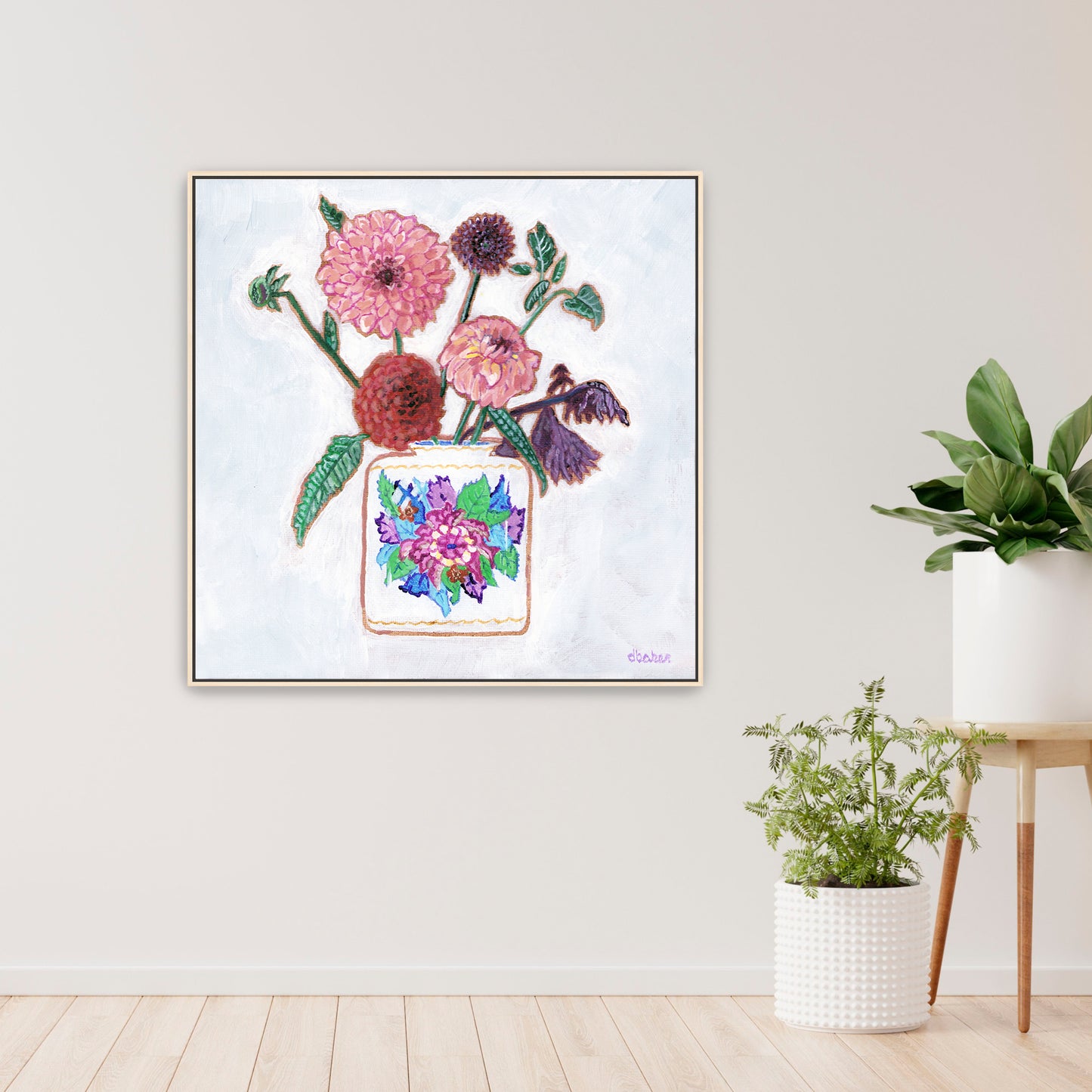 Vibrant dahlias bloom from a classic tobacco leaf vase, blending bold color, texture, and tradition in a modern still life