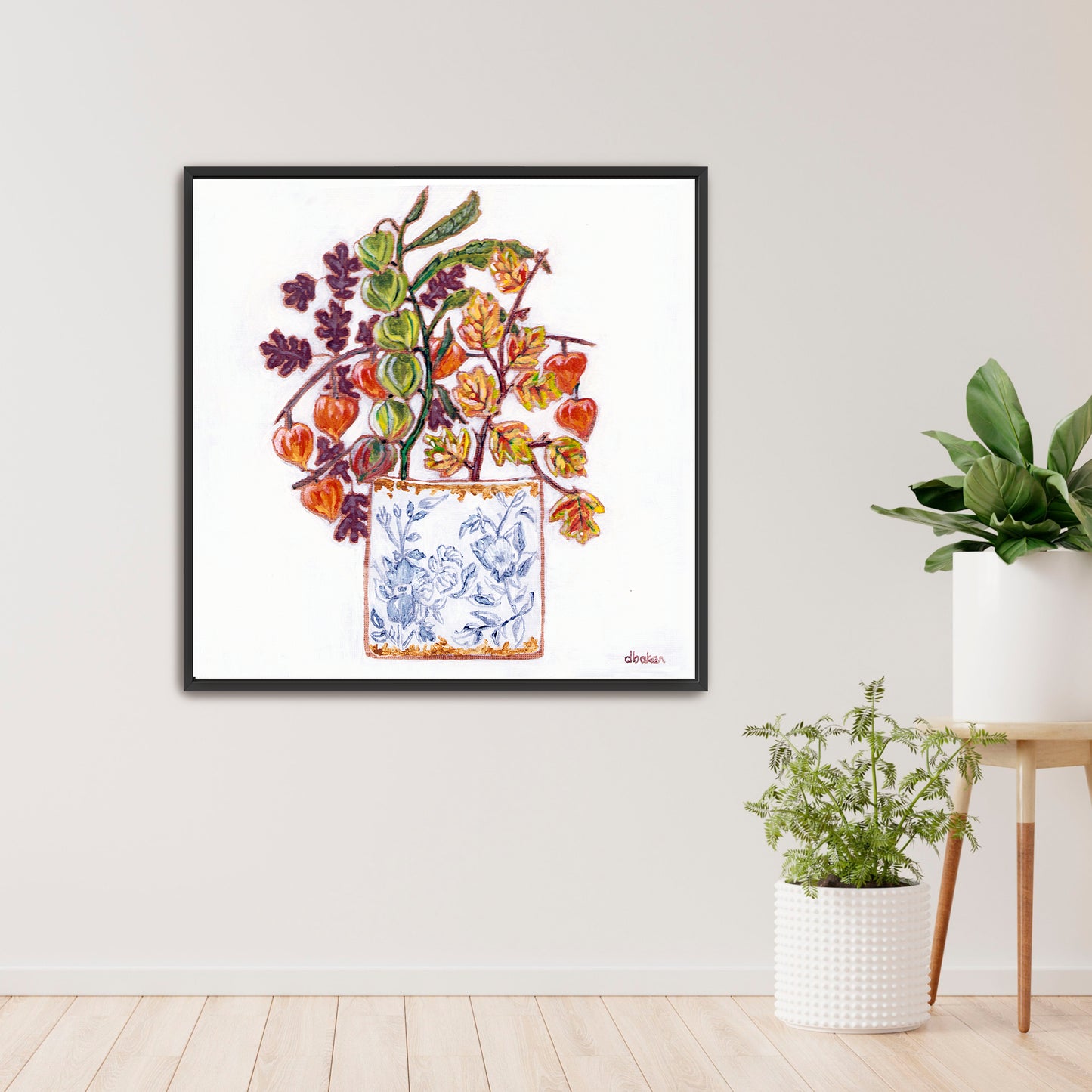A delicate still life featuring vibrant orange and green lantern flowers arranged in a blue-and-white porcelain vase.