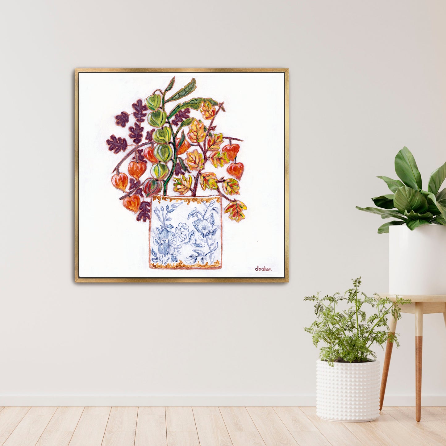 A delicate still life featuring vibrant orange and green lantern flowers arranged in a blue-and-white porcelain vase.