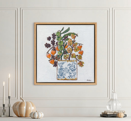 A delicate still life featuring vibrant orange and green lantern flowers arranged in a blue-and-white porcelain vase.
