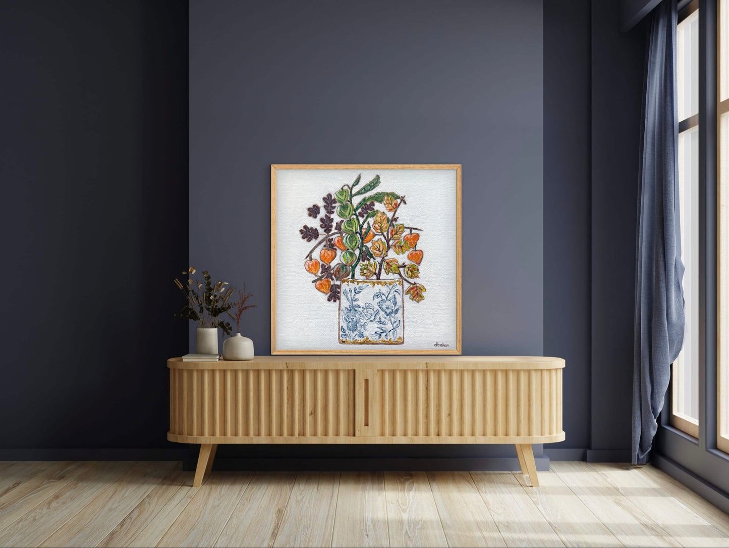A delicate still life featuring vibrant orange and green lantern flowers arranged in a blue-and-white porcelain vase.