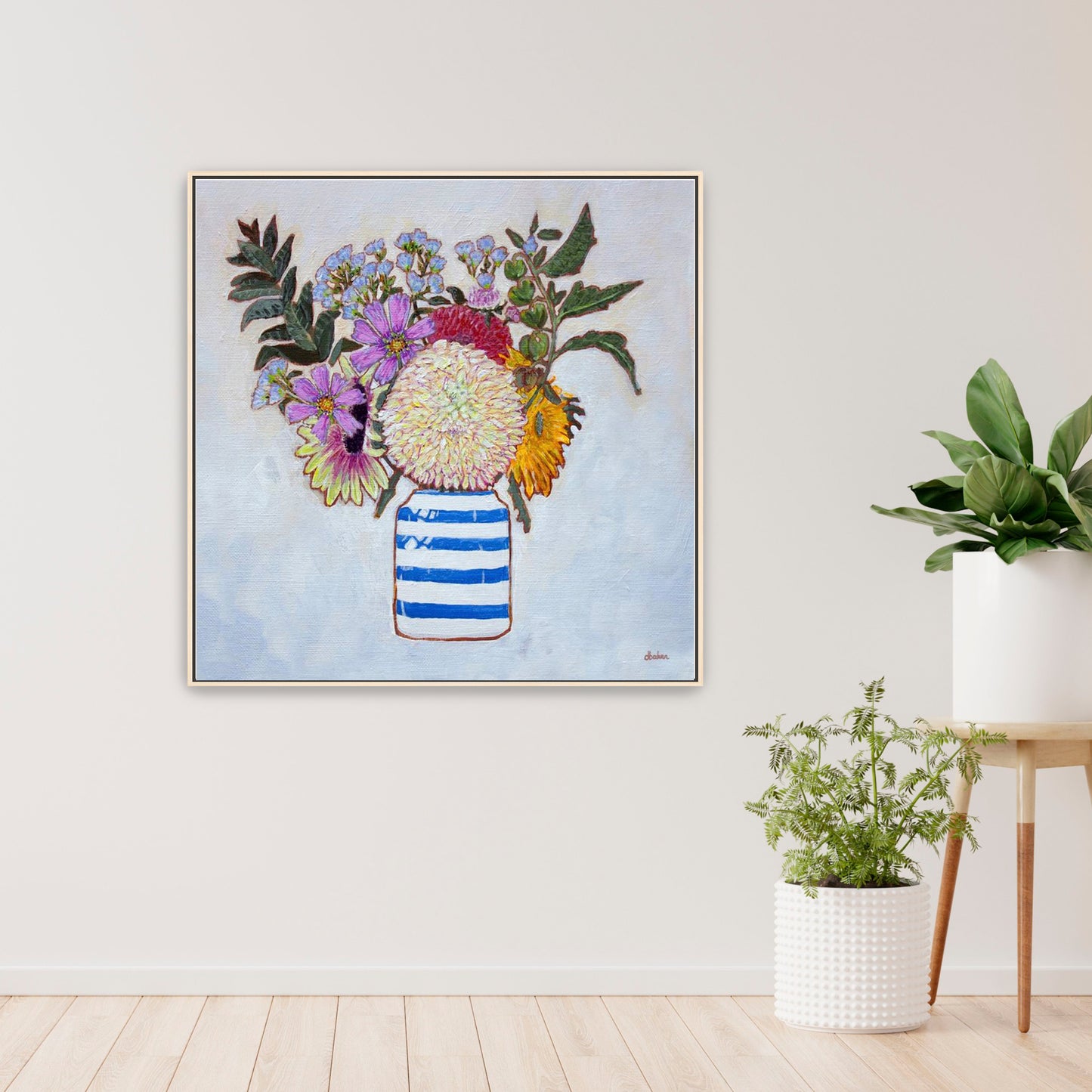 A whimsical and colorful painting of dahlias and wildflowers in a blue and white striped vase.