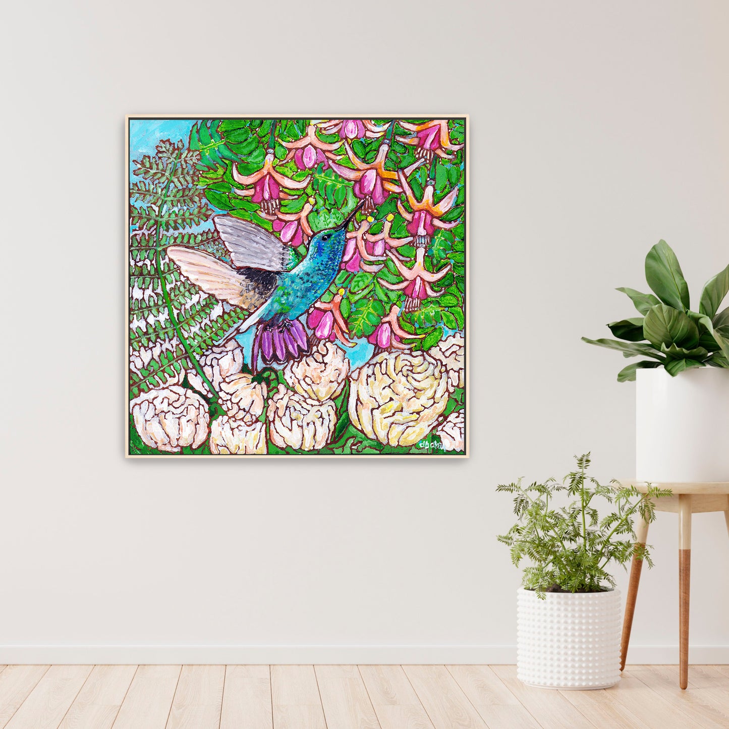 A colorful painting of a hummingbird in a fuchsia flower plant hovering over peony flowers.