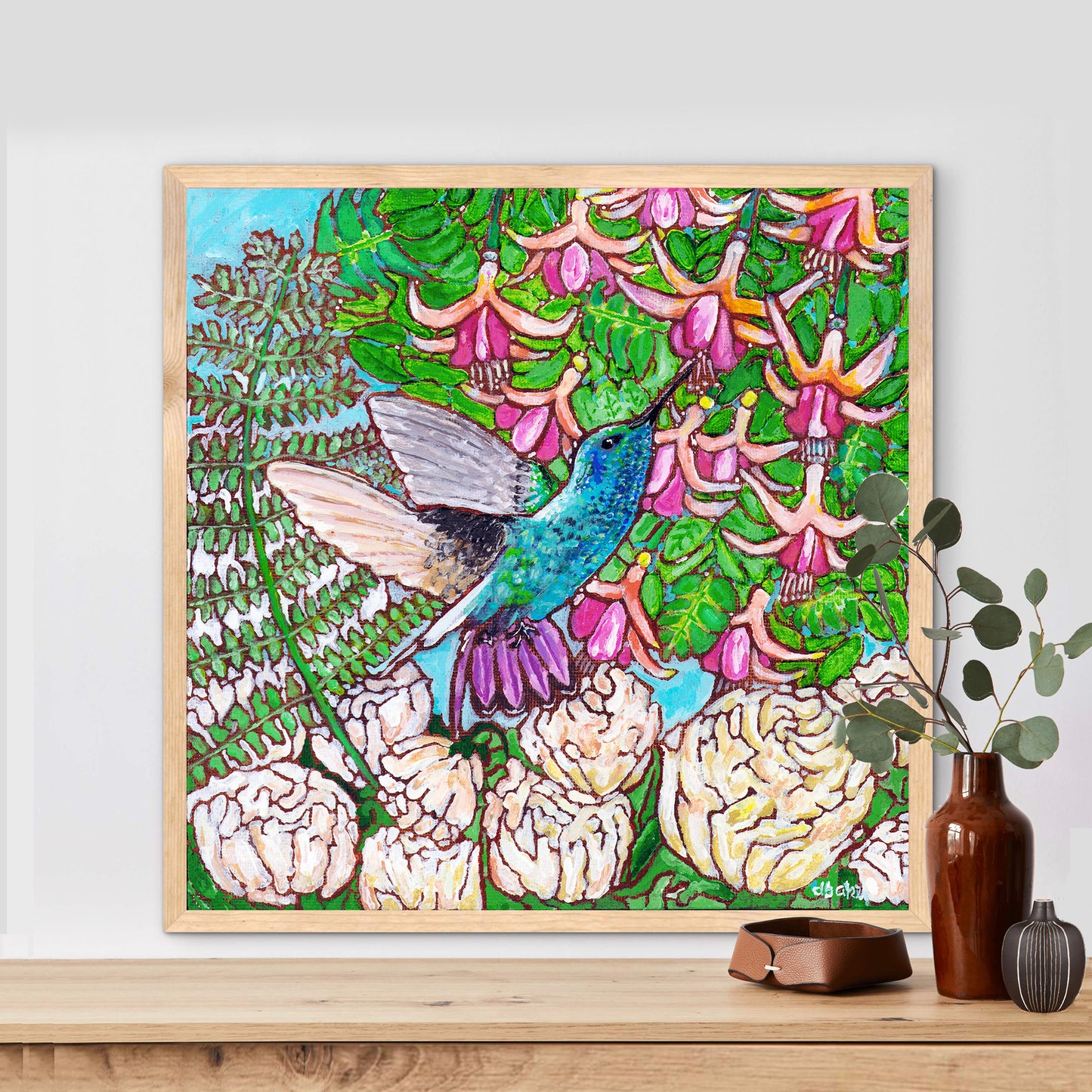 A colorful painting of a hummingbird in a fuchsia flower plant hovering over peony flowers.