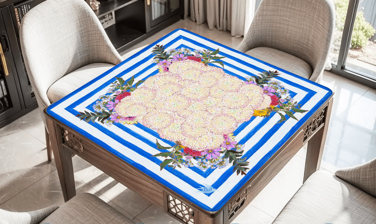A whimsical and colorful mahjong mat based on a  painting of dahlias and wildflowers in a blue and white striped vase.