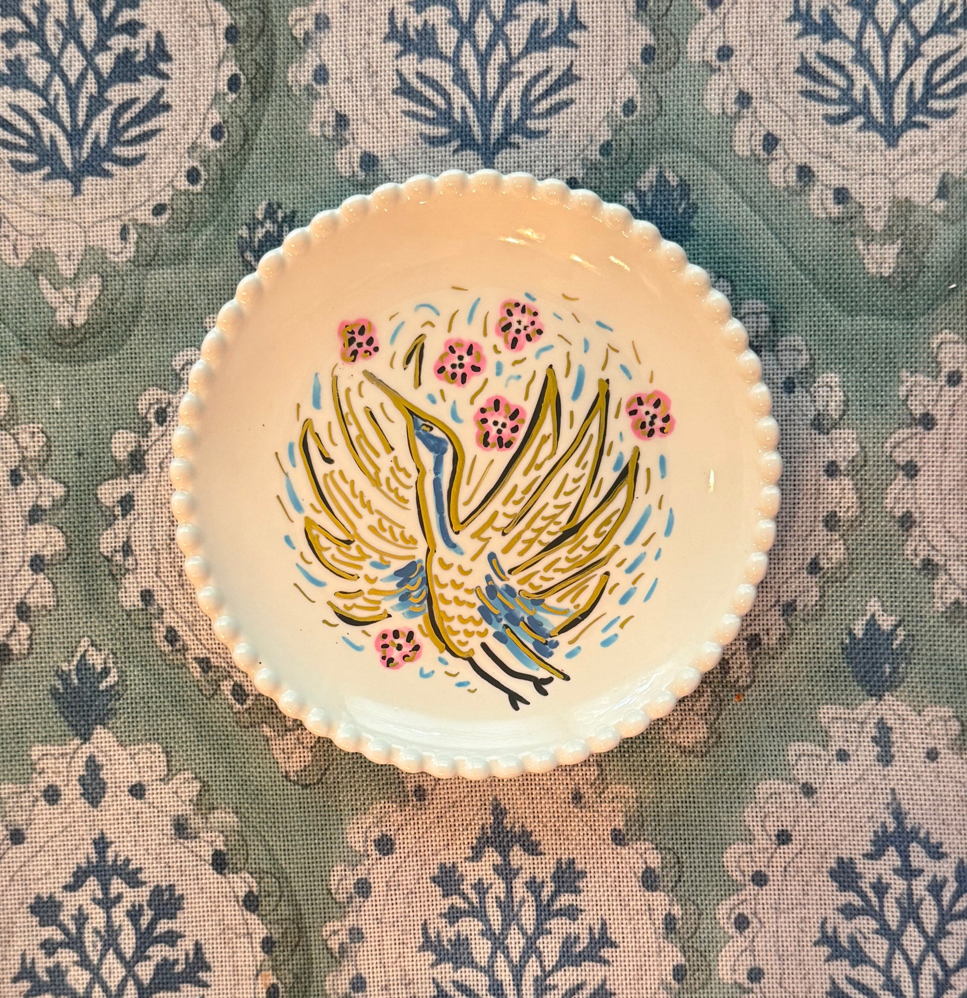 A hand painted cricket tray featuring a heron from Trail East Studio in Ada Michigan makes the perfect hostess gift.