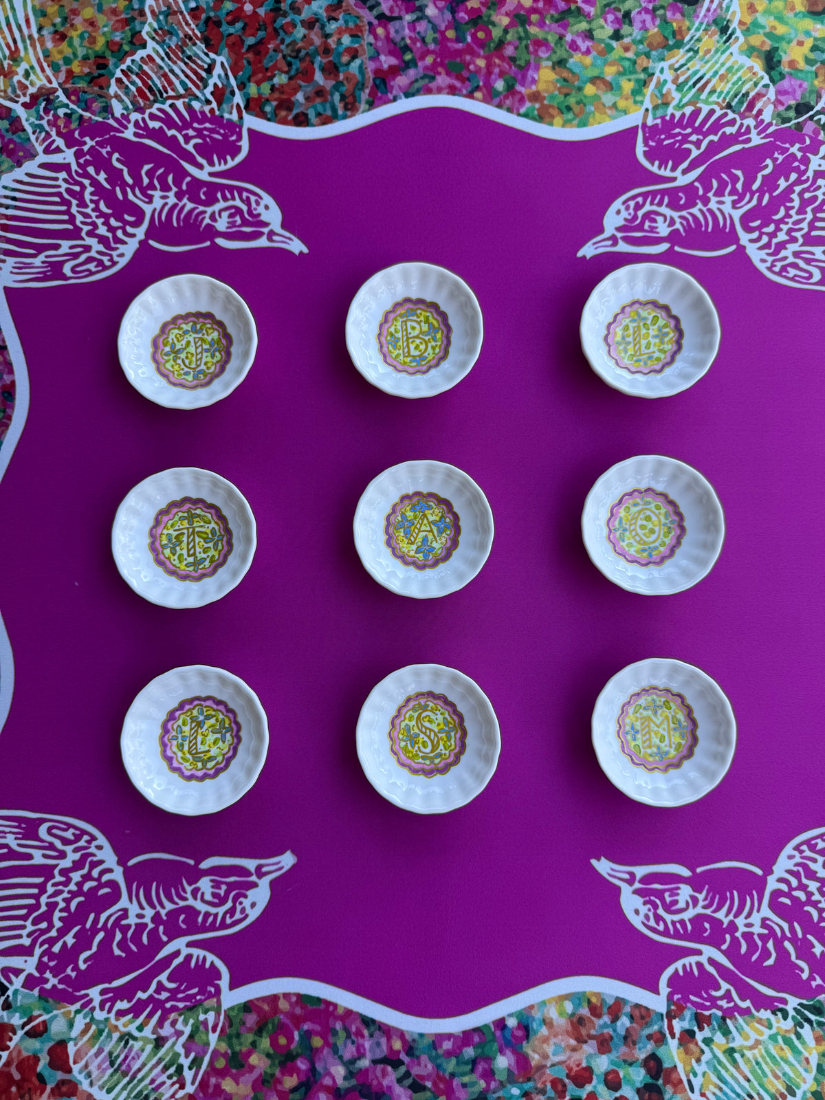 A hand painted monogrammed dice dishes featuring a floral motif from Trail East Studio in Ada Michigan