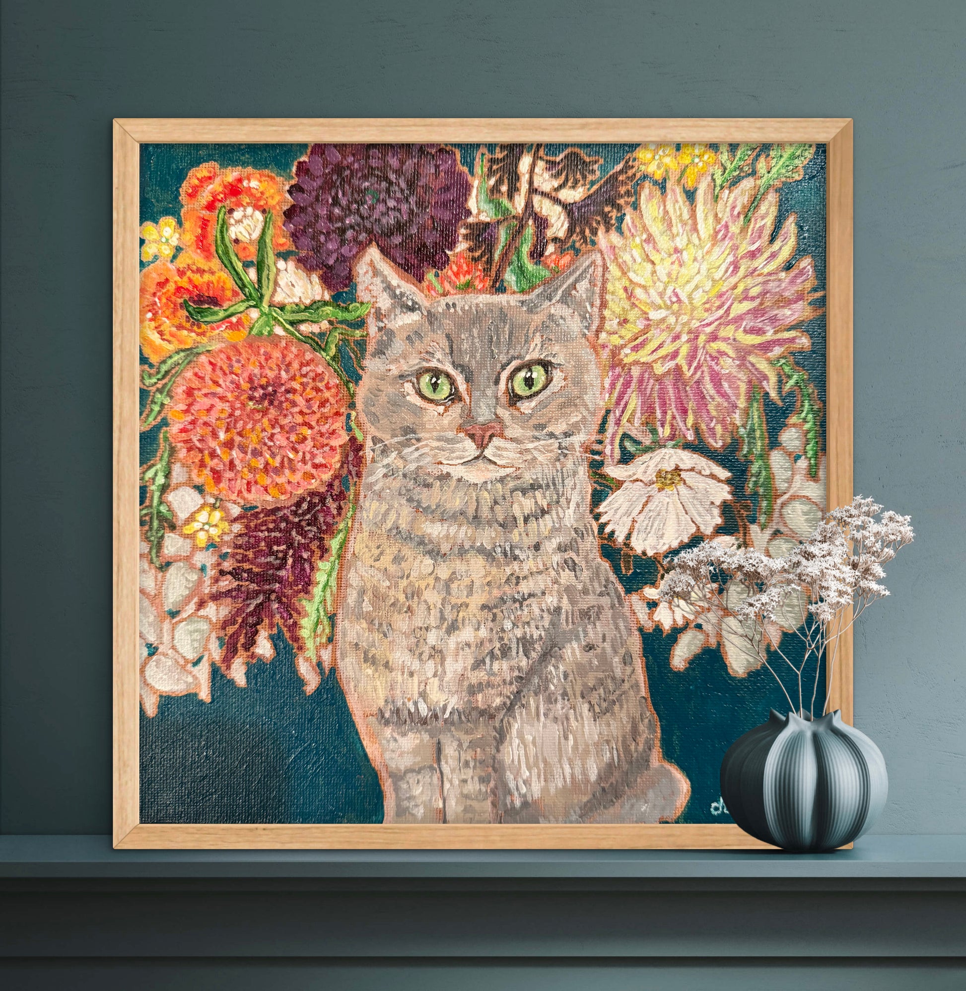 This painting is a loving portrait of Moses my gray cat shown sitting calmly in front of a rich bouquet of flowers including vibrant dahlias.