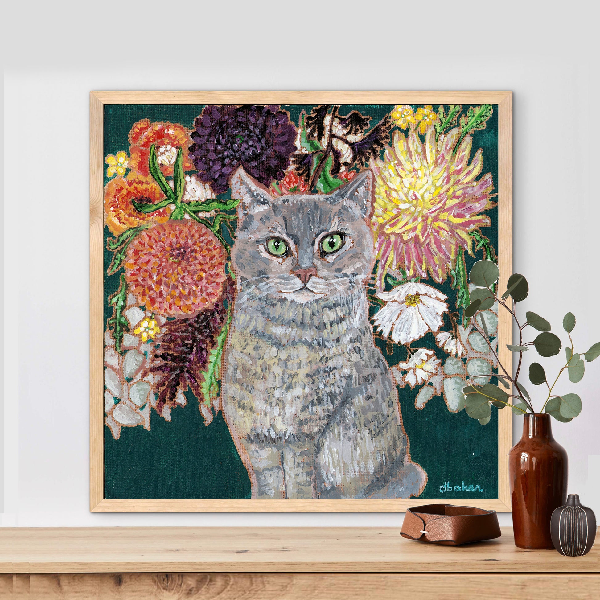 This painting is a loving portrait of Moses my gray cat shown sitting calmly in front of a rich bouquet of flowers including vibrant dahlias.