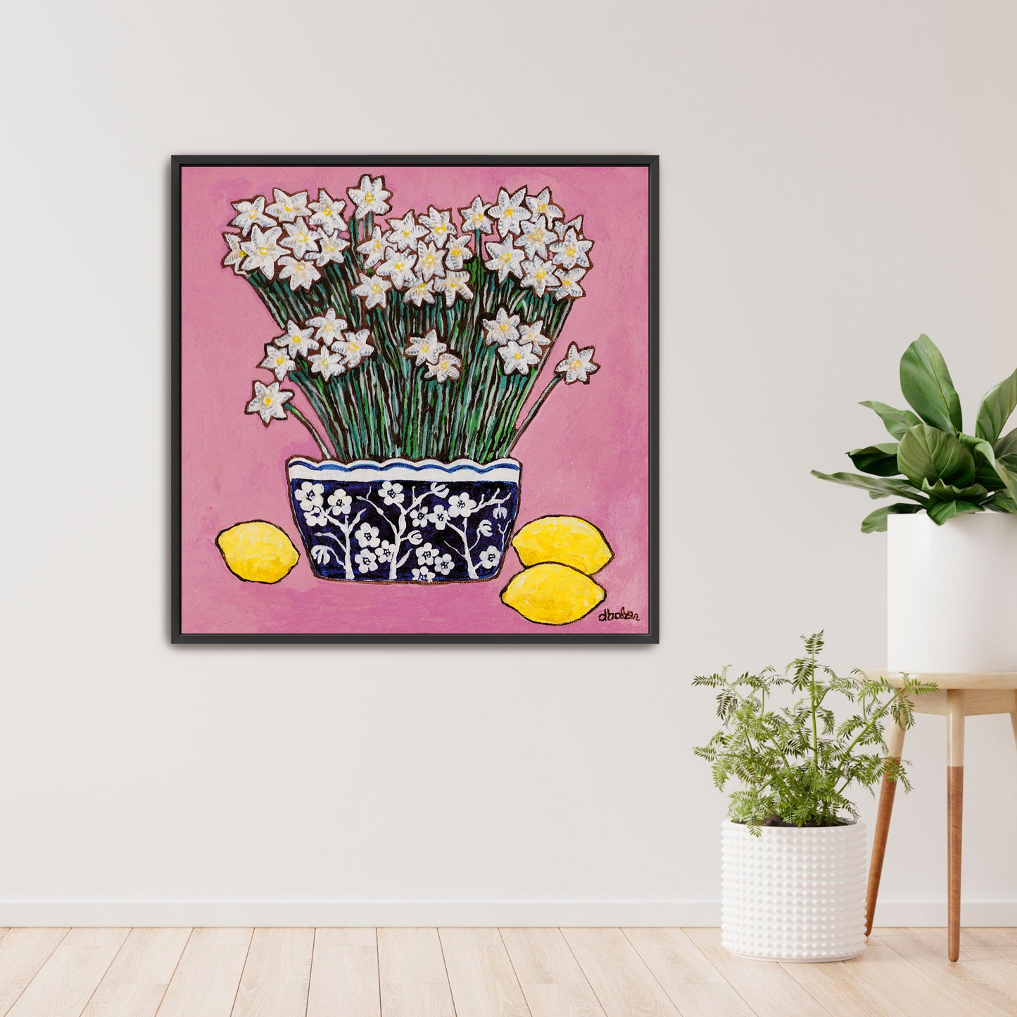 A whimsical painting of paperwhites in a blue and white floral vase surrounded by lemons against a bright pink background.