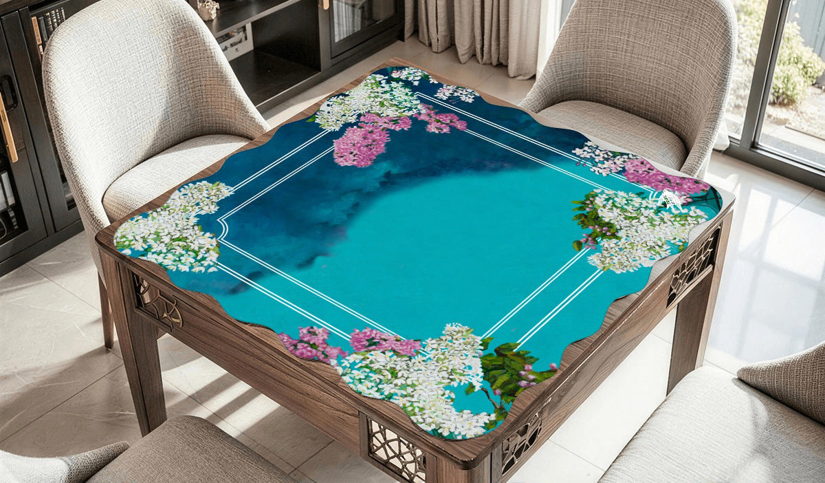 A mahjong mat featuring an original painting of a still life painting of lilacs in blue and green glass bottles.