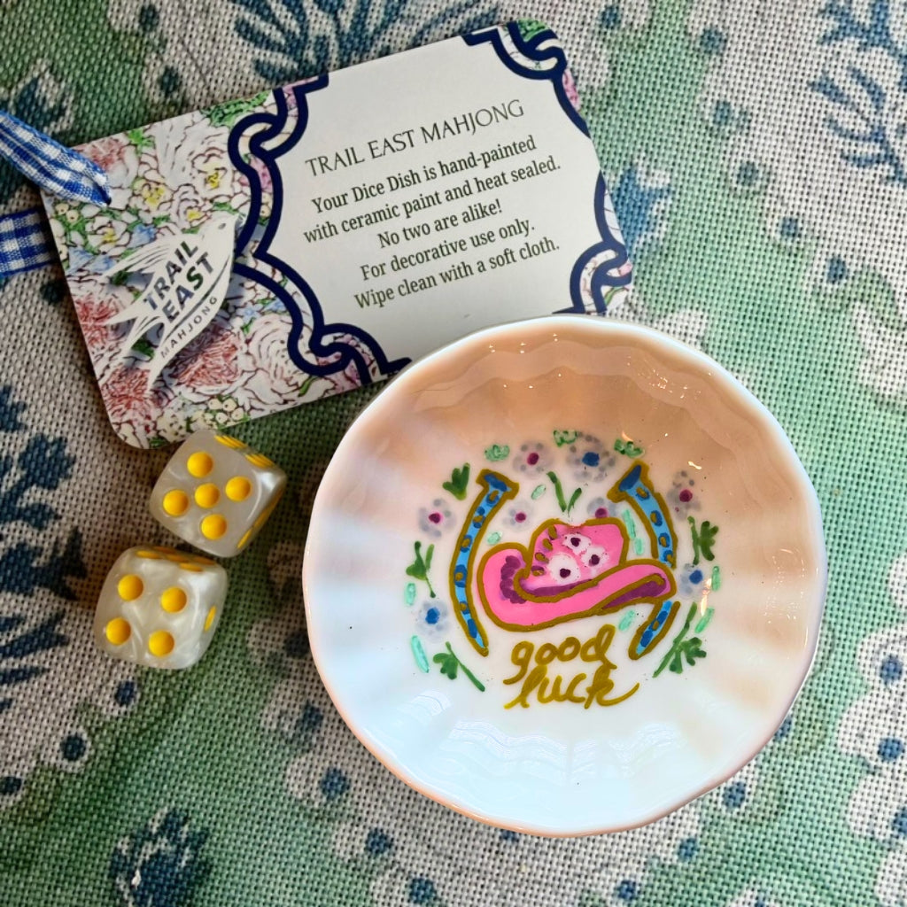 A hand painted Mahjong Dice Dish with a pink cowboy hat motif from Trail East Studio. The perfect hostess gift.