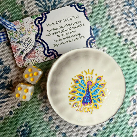 A hand painted Mahjong Dice Dish with a vintage  lucky peacock motif from Trail East Studio. The perfect hostess gift.