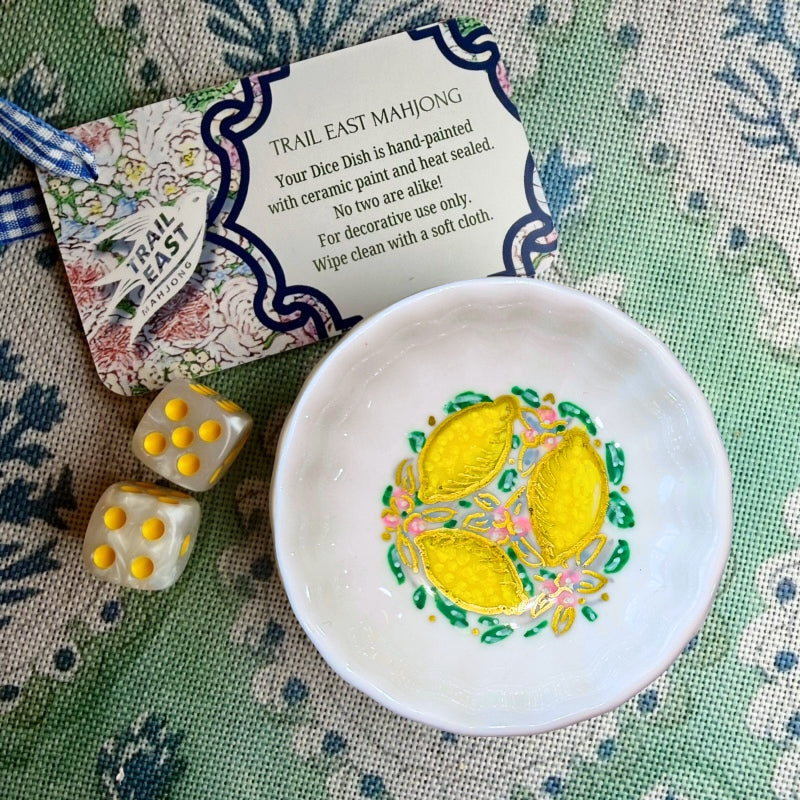A hand painted dice dish from Trail East Studio featuring a lemons and flowers.