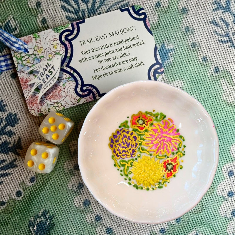 A hand painted dice dish from Trail East Studio featuring dahlias and peonies.