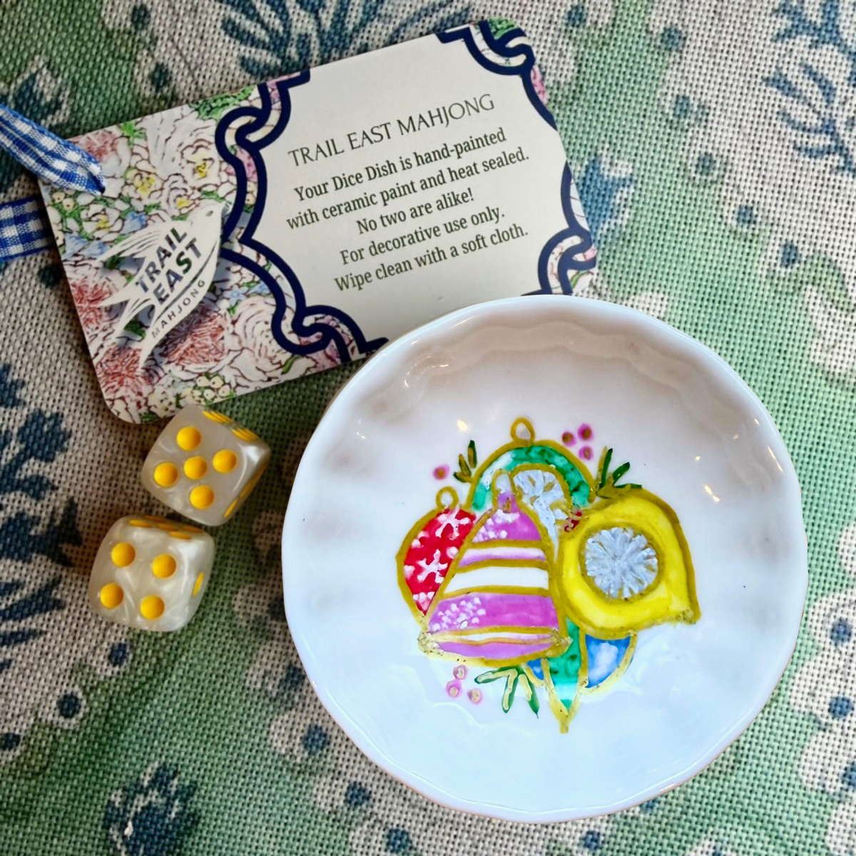 A hand painted mahjong dice dish featuring vintage holiday ornaments by Deb Baker of Trail East Studios in Ada Michigan