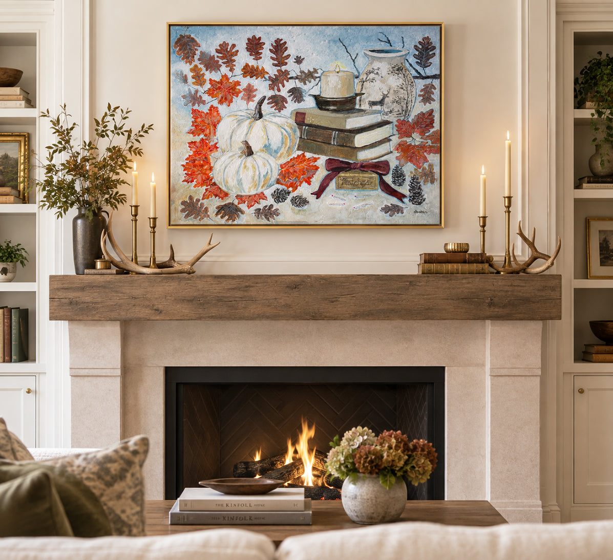 An original painting Cozy October by Deb Baker of Trail  East Studio in Ada Michigan of books, leaves, pumpkins, a candle, a decorative vase and matches with a velvet bow.