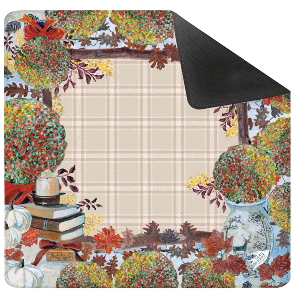 The Original Painting Cozy Fall Mahjong Mat by Trail East Studio. A colorful fall illustrations of pumpkins, leaves, mums, books and a lit candle.